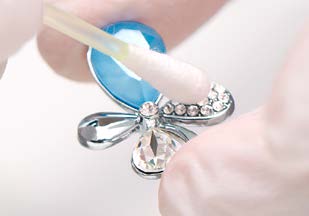 Removing excess glue around a crystal