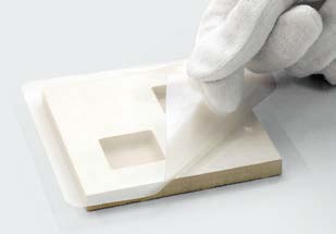Applying protective film over material