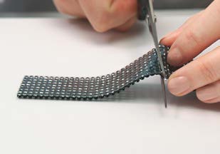 Cutting metal mesh with scissors