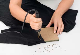 Hotfix element positioned on the carrier material after the adhesive has melted