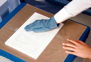 Additional pressure applied with a pressing cloth after heat application