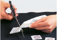 Cutting transparent transfer film close to the motif