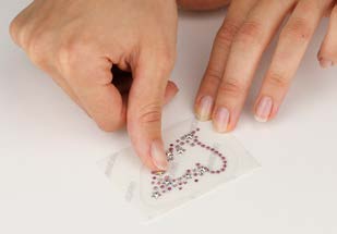 Pressing Crystal-it Infinity crystals onto the transparent film