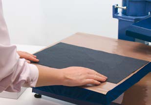 Placing carrier material face down in a heat press